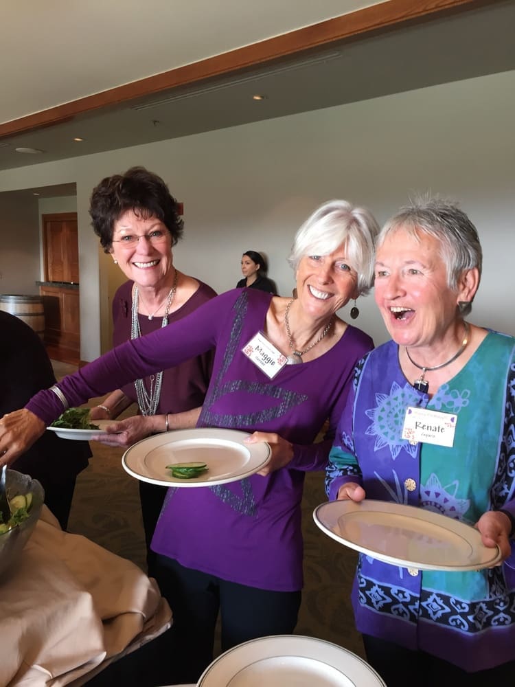 The ladies in purple share a laugh waiting in the food line.