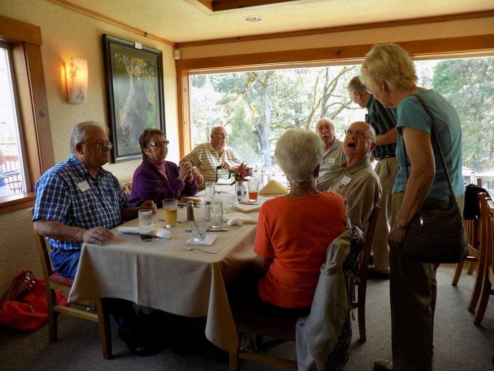 Bob McIntyre and Russ and Terry Noble enjoy a table with a beautiful view of the Rogue River.